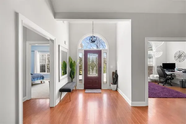 an empty room with wooden floor and fireplace