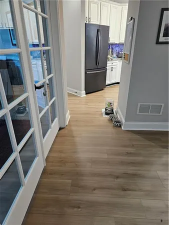 wooden floor fireplace and windows in an empty room
