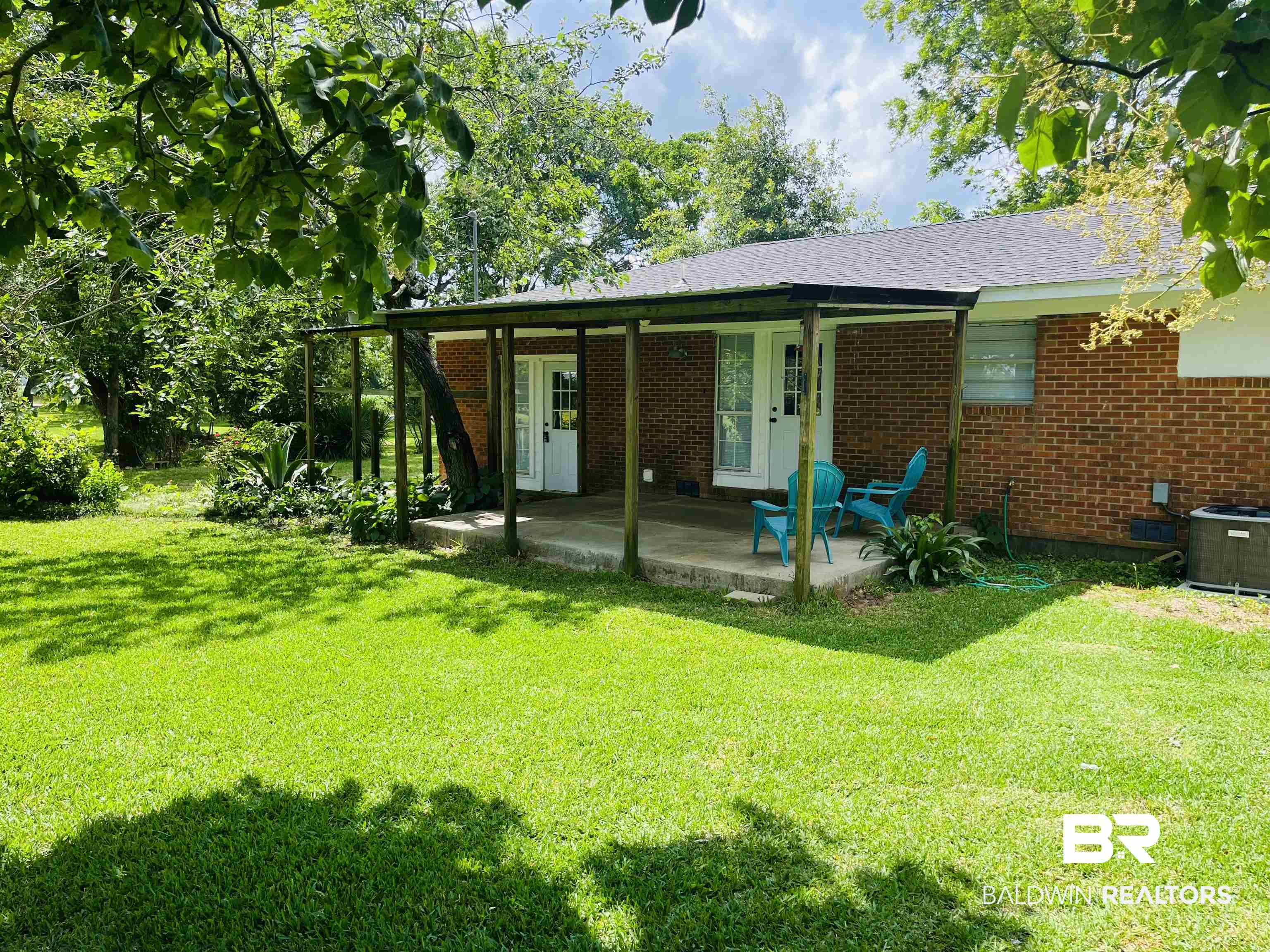 16799 Hinote Glass Road Loxley, AL 36551 - Photo 21 of 26 View of front of home featuring a front yard, a patio area, and brick siding