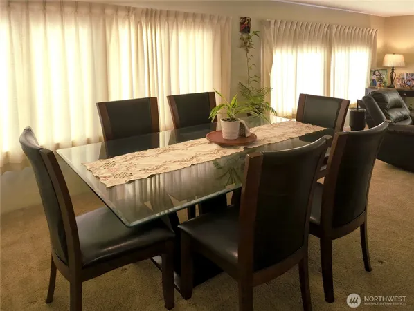 a view of a dining room with furniture and window