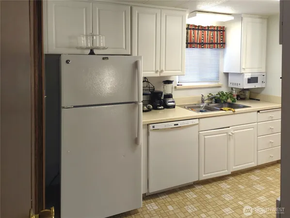 a white refrigerator freezer sitting in a kitchen