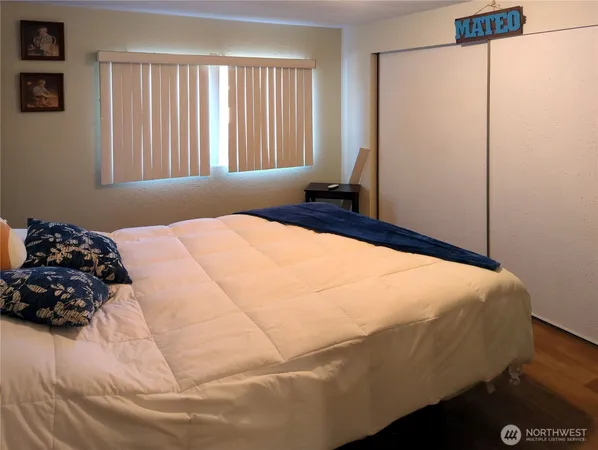 a bed sitting in a bedroom next to a window