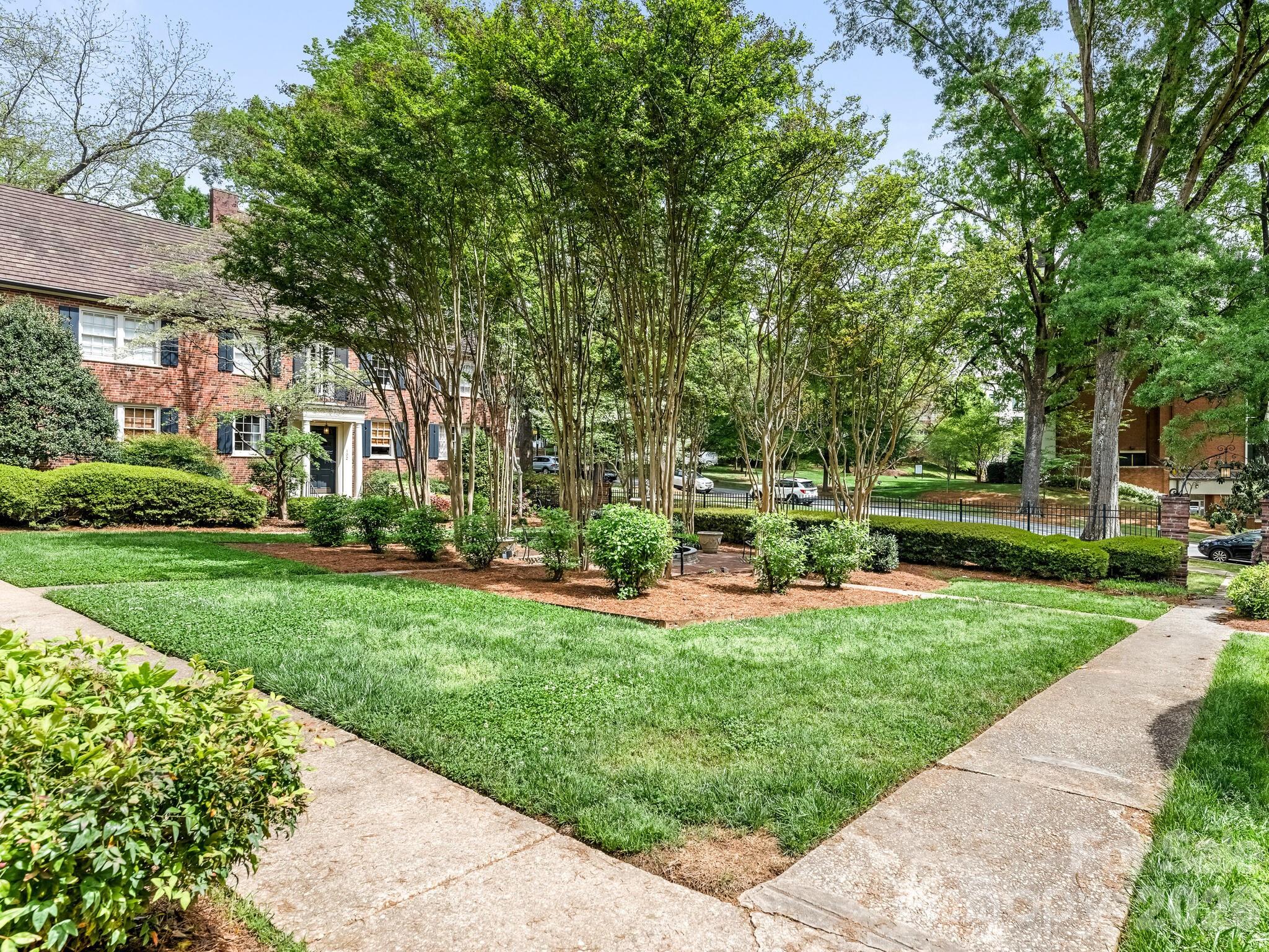 108 Colville Road, Unit 22A Charlotte, NC 28207 - Photo 13 of 14 a view of a house with a yard and sitting area