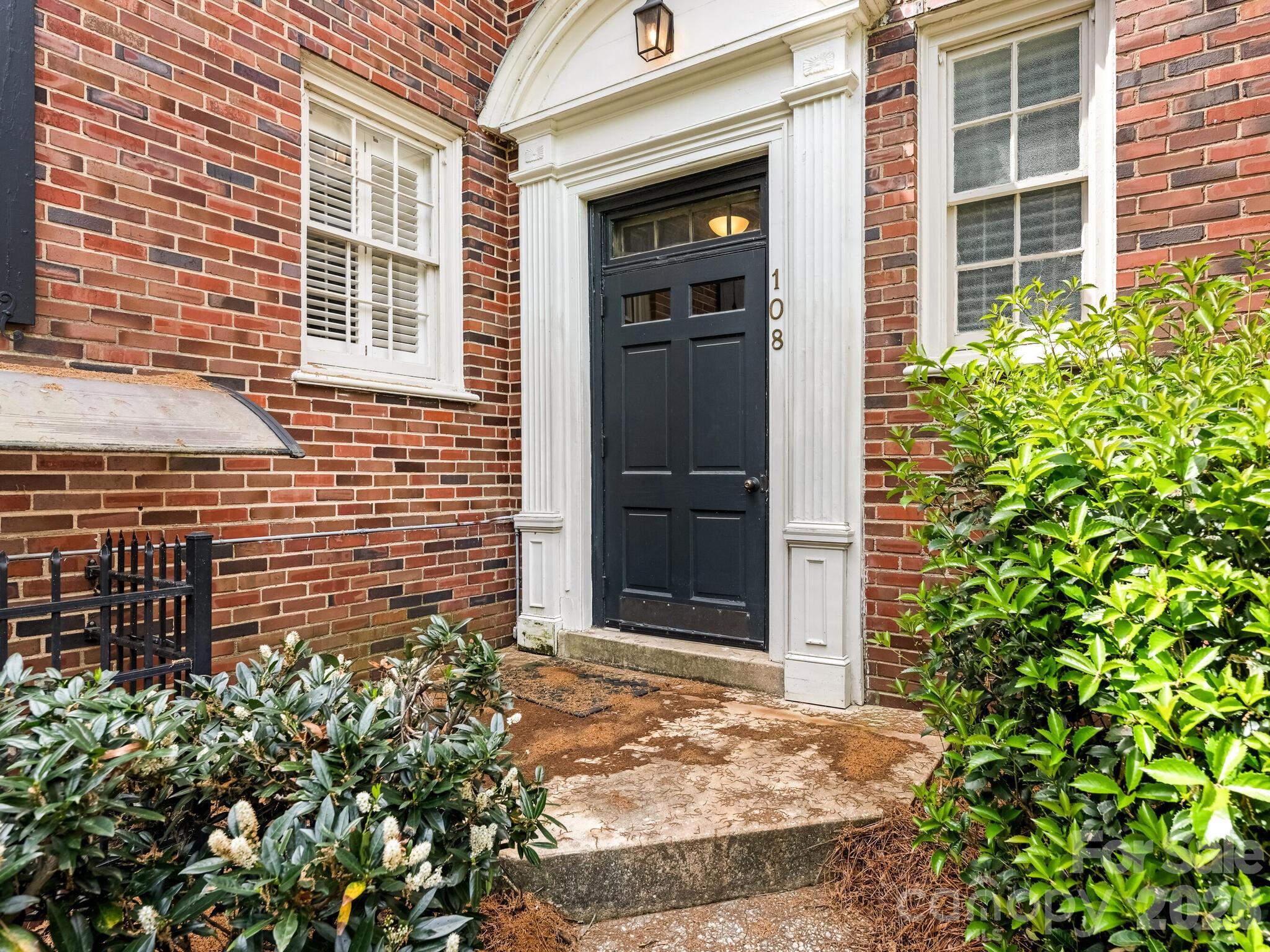 108 Colville Road, Unit 22A Charlotte, NC 28207 - Photo 2 of 14 front view of a brick house with a large windows