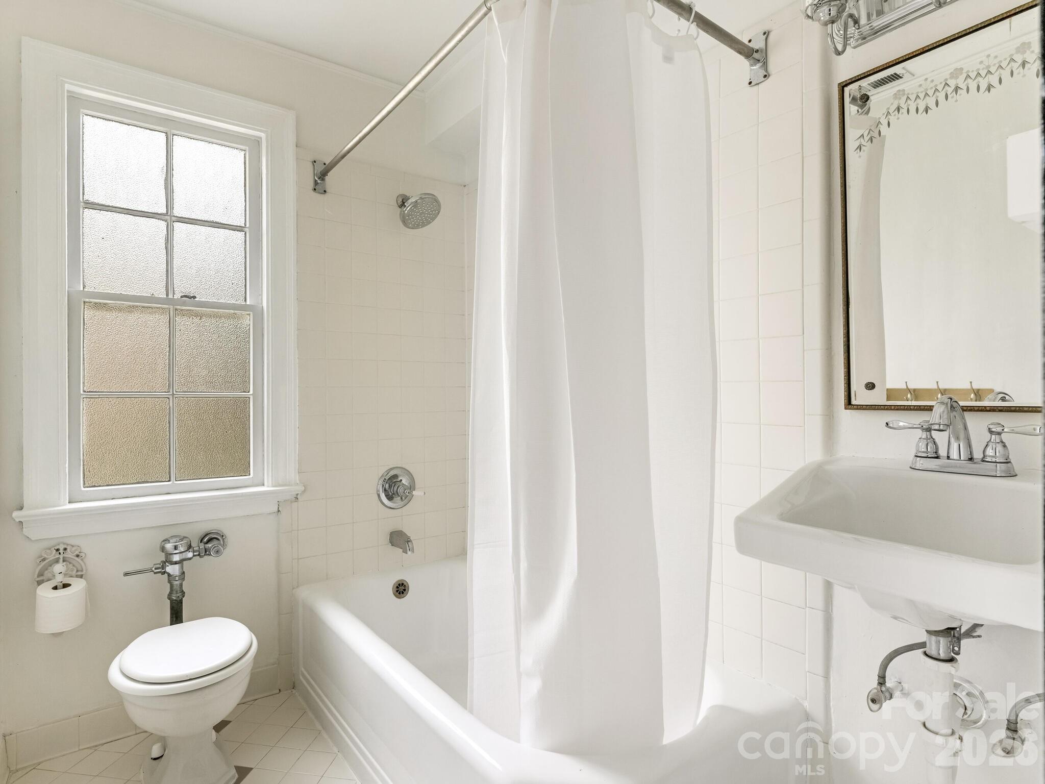 108 Colville Road, Unit 22A Charlotte, NC 28207 - Photo 10 of 14 a bathroom with a sink and a mirror