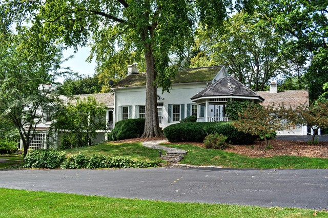 36W841 Crane Road St. Charles, IL 60174 - Photo 1 of 25 a front view of a house with a yard and potted plants