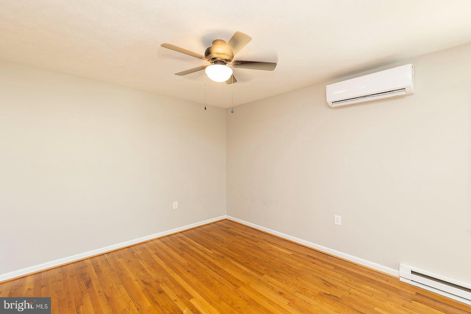 174 Double Church Road Stephens City, VA 22655 - Photo 15 of 29 a view of a room with wooden floor and a ceiling fan