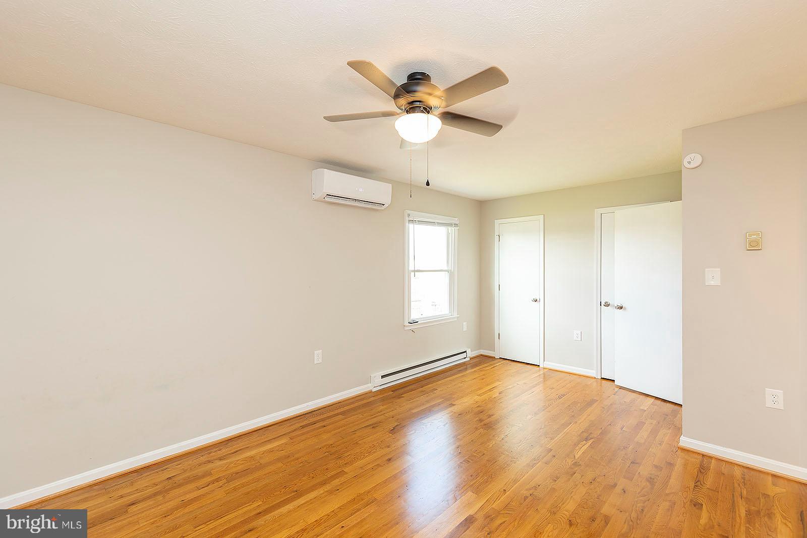 174 Double Church Road Stephens City, VA 22655 - Photo 16 of 29 a view of a room with wooden floor and a ceiling fan