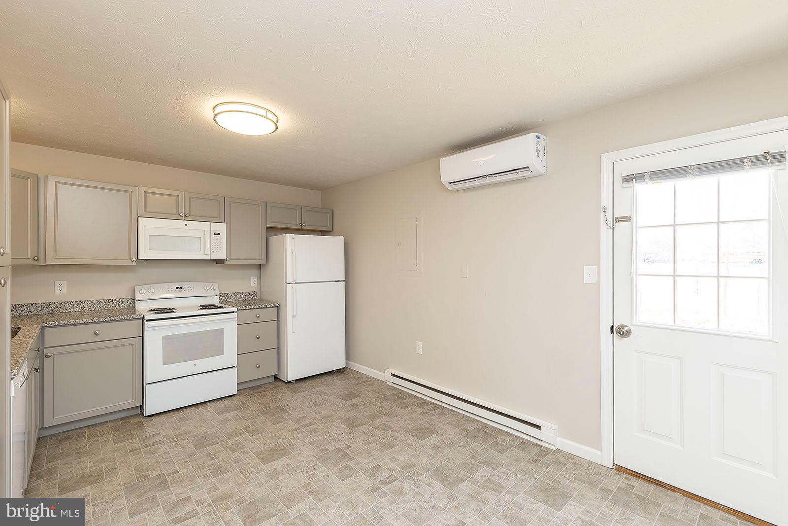 174 Double Church Road Stephens City, VA 22655 - Photo 6 of 29 a kitchen with a stove top oven and white kitchen