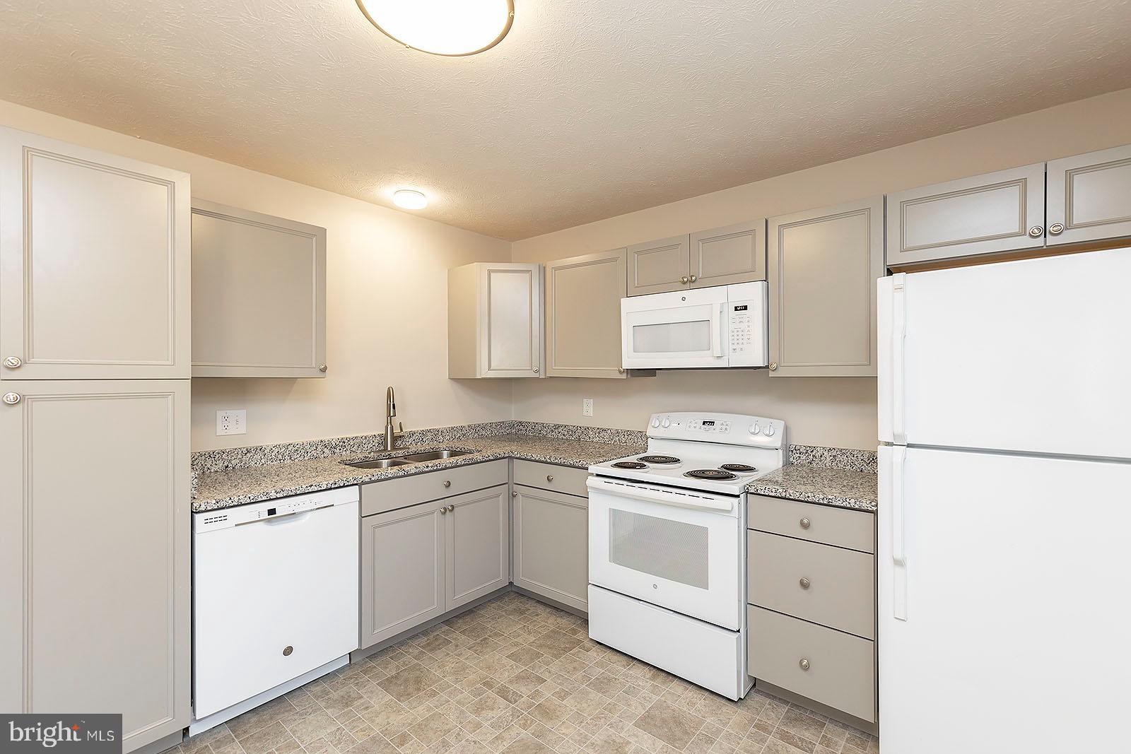 174 Double Church Road Stephens City, VA 22655 - Photo 8 of 29 a kitchen with white cabinets and white appliances