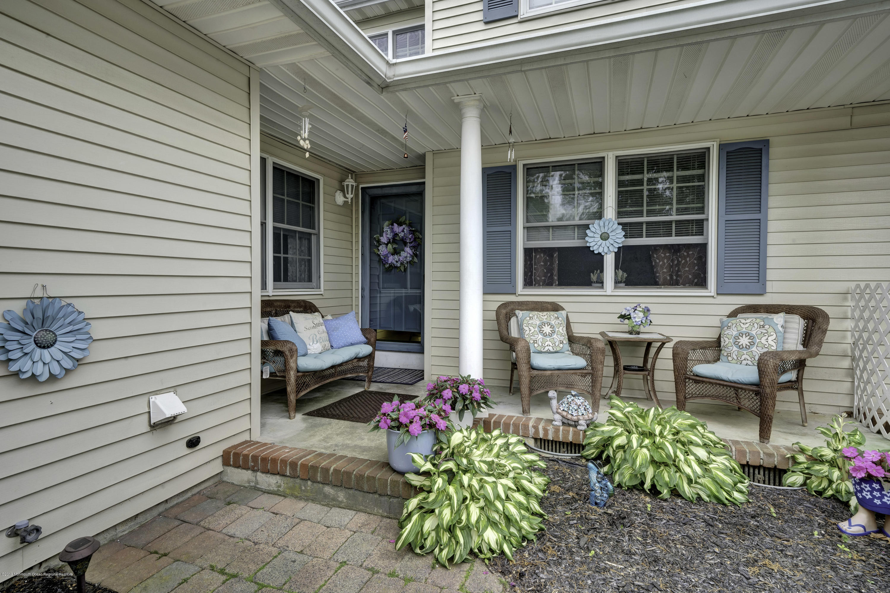 a front view of a house with outdoor seating