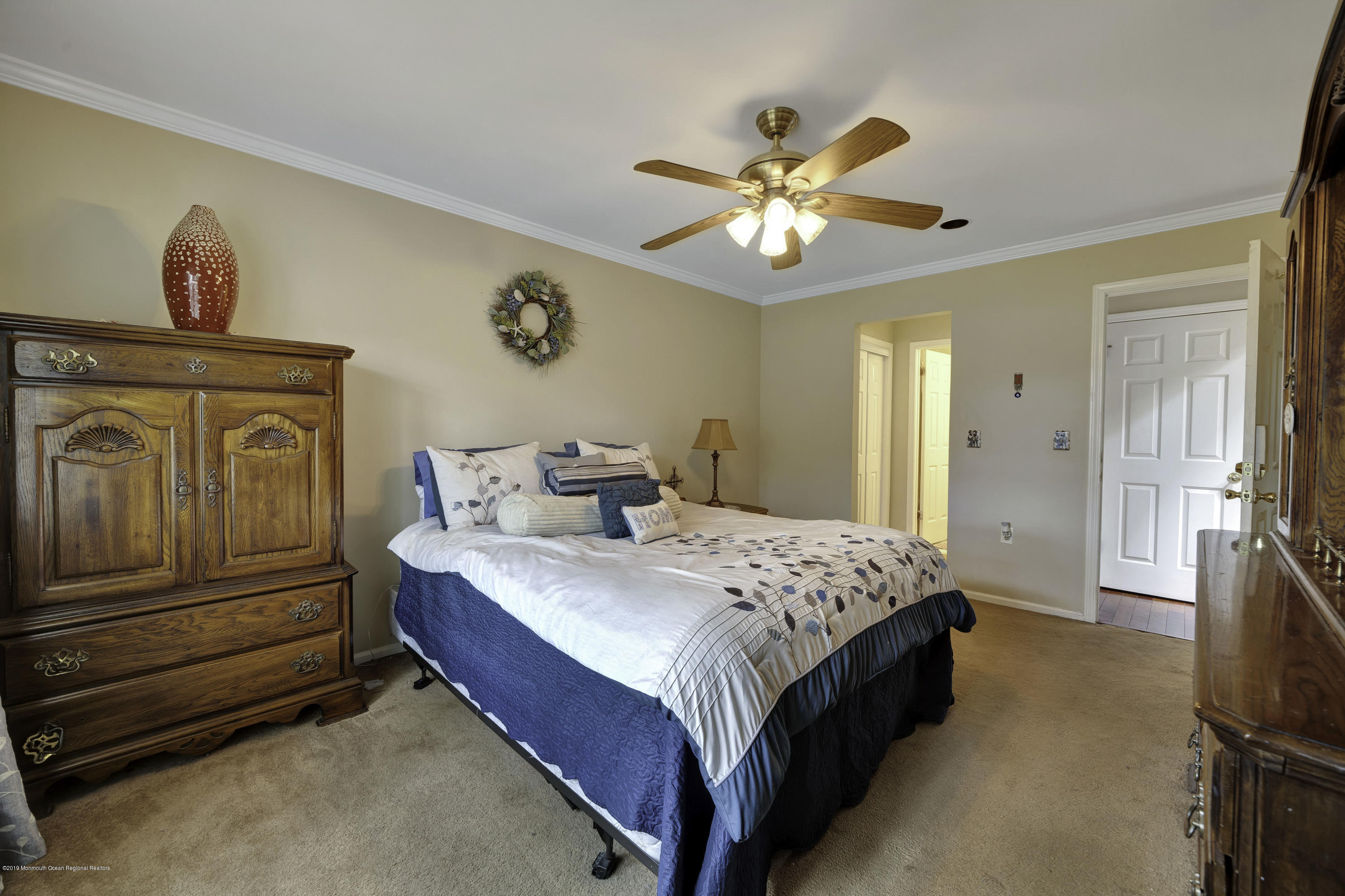 2 Cherrywood Circle, Unit 102 Brick, NJ 08724 - Photo 15 of 26 a spacious bedroom with a bed and a chandelier