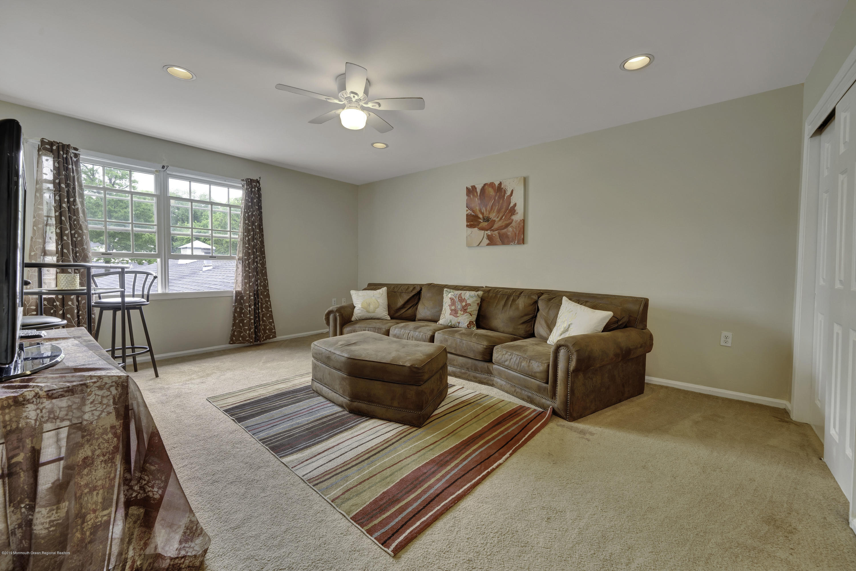 2 Cherrywood Circle, Unit 102 Brick, NJ 08724 - Photo 20 of 26 a living room with furniture and a large window