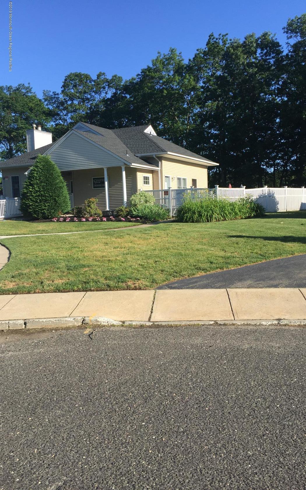 2 Cherrywood Circle, Unit 102 Brick, NJ 08724 - Photo 23 of 26 a front view of a house with a yard and garage