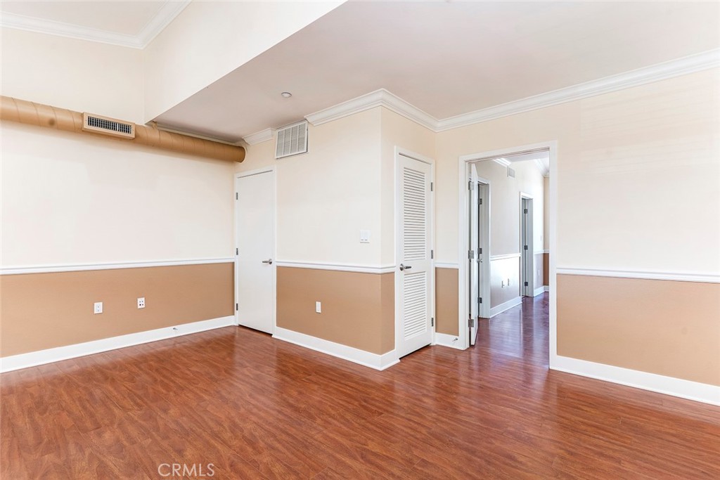 596 South Brea Boulevard Brea, CA 92821 - Photo 22 of 33 an empty room with wooden floor and windows
