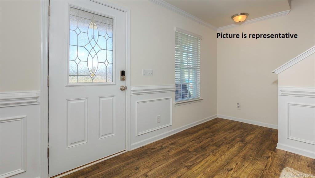 8008 Starnes Randall Road Charlotte, NC 28215 - Photo 2 of 25 a view of an empty room with wooden floor and a window