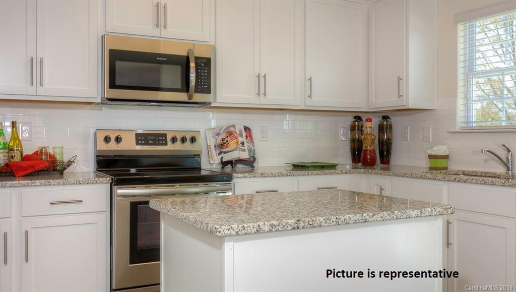 8008 Starnes Randall Road Charlotte, NC 28215 - Photo 11 of 25 a kitchen with granite countertop a sink and white cabinets