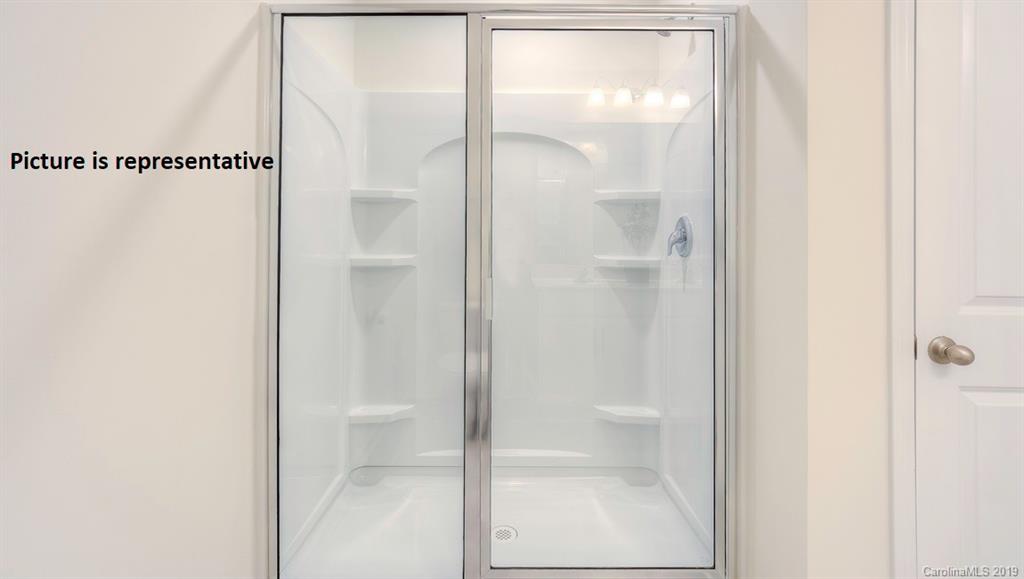 8008 Starnes Randall Road Charlotte, NC 28215 - Photo 13 of 25 a bathroom with a glass shower door