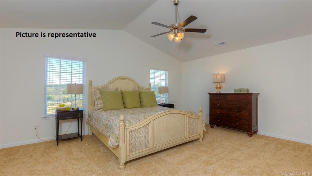 8008 Starnes Randall Road Charlotte, NC 28215 - Photo 16 of 25 a bedroom with a bed and a chandelier