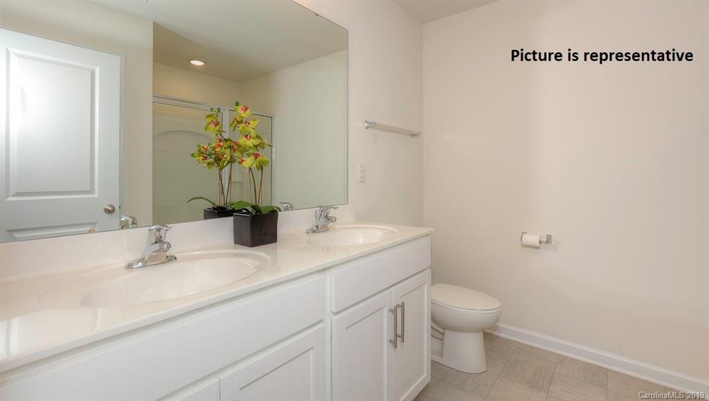 8008 Starnes Randall Road Charlotte, NC 28215 - Photo 23 of 25 a bathroom with a granite countertop sink a toilet and a mirror
