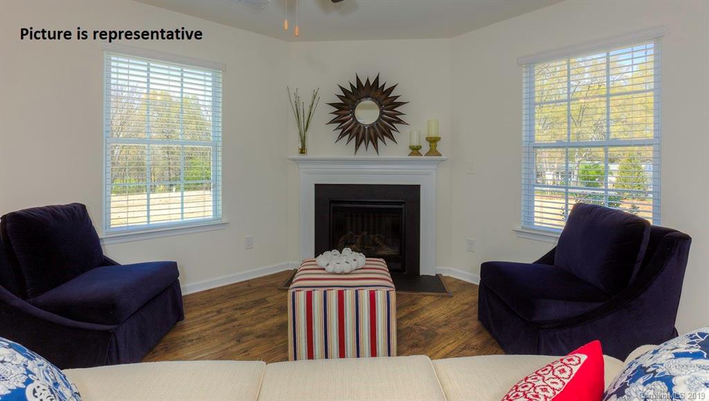 8008 Starnes Randall Road Charlotte, NC 28215 - Photo 4 of 25 a living room with furniture and a fireplace