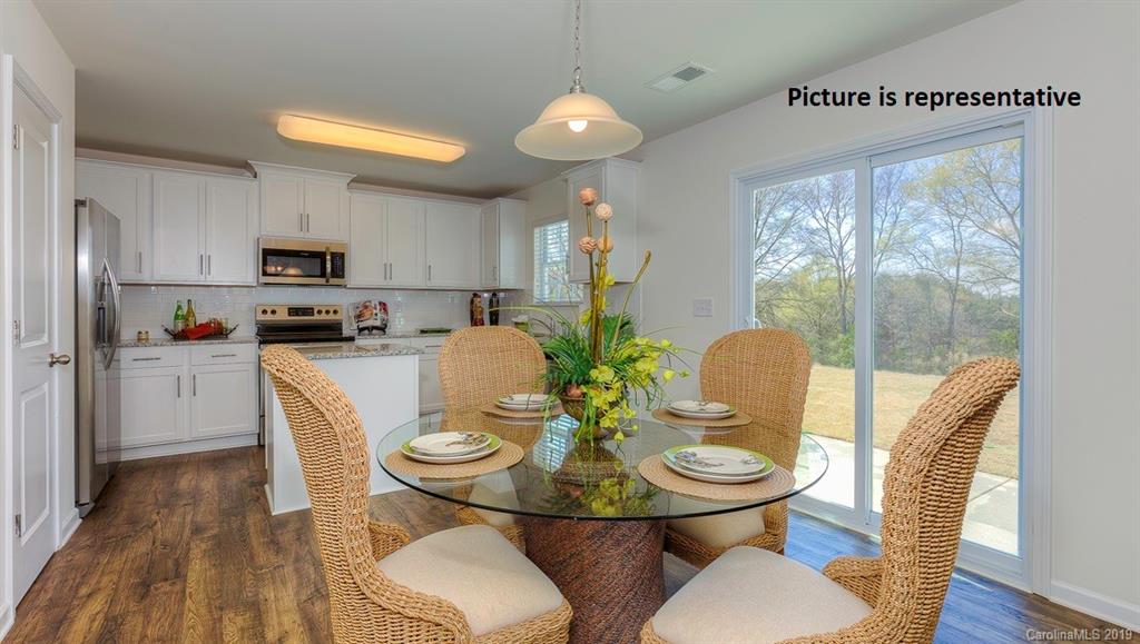 8008 Starnes Randall Road Charlotte, NC 28215 - Photo 6 of 25 a kitchen with sink refrigerator dining table and chairs
