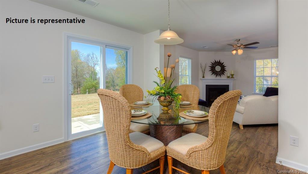 8008 Starnes Randall Road Charlotte, NC 28215 - Photo 7 of 25 a dining room with furniture a livingroom and wooden floor