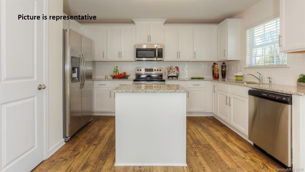 8008 Starnes Randall Road Charlotte, NC 28215 - Photo 10 of 25 a kitchen with stainless steel appliances a refrigerator sink and white cabinets