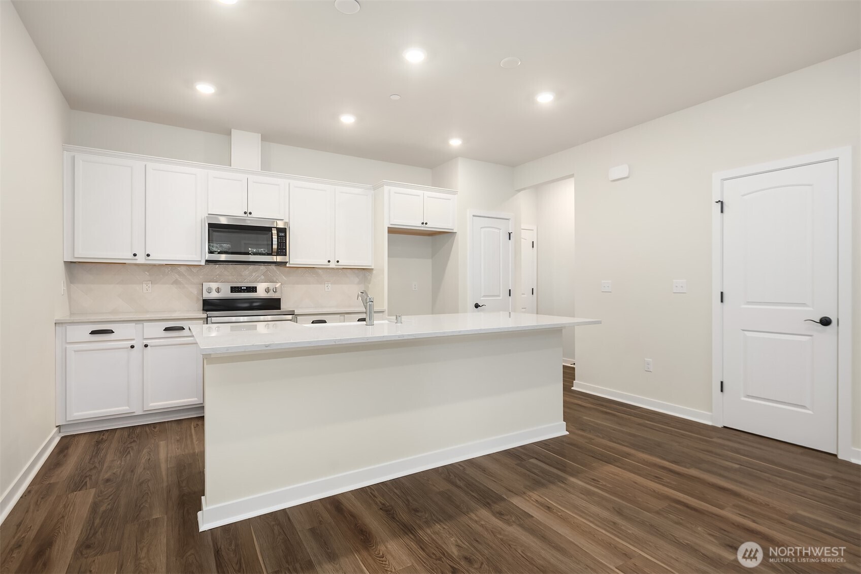 31840 Myrtle Street Carnation, WA 98014 - Photo 7 of 22 a kitchen with kitchen island a sink and a stove top oven