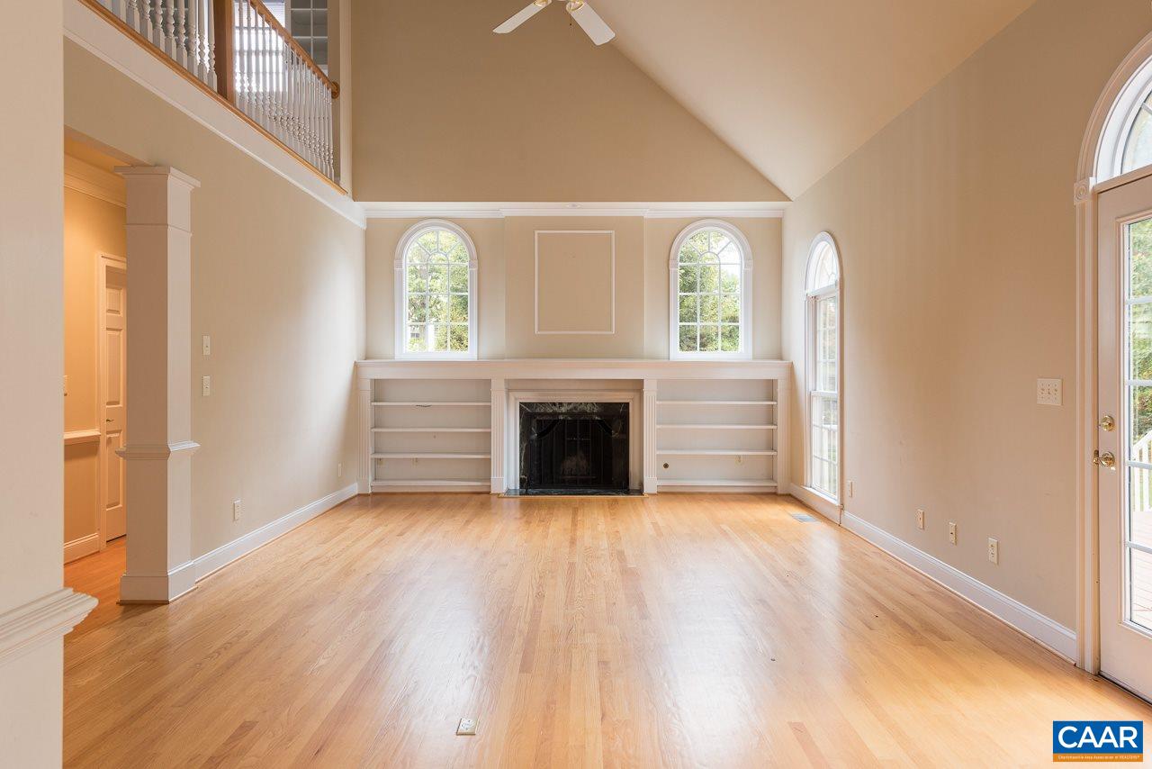 3464 Darby Road Keswick, VA 22947 - Photo 9 of 35 a view of empty room with wooden floor and fireplace