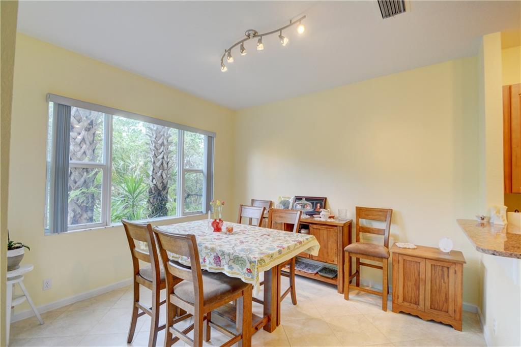 138 Southwest Walking Path Stuart, FL 34997 - Photo 11 of 50 a view of a dining room with furniture window and outside view