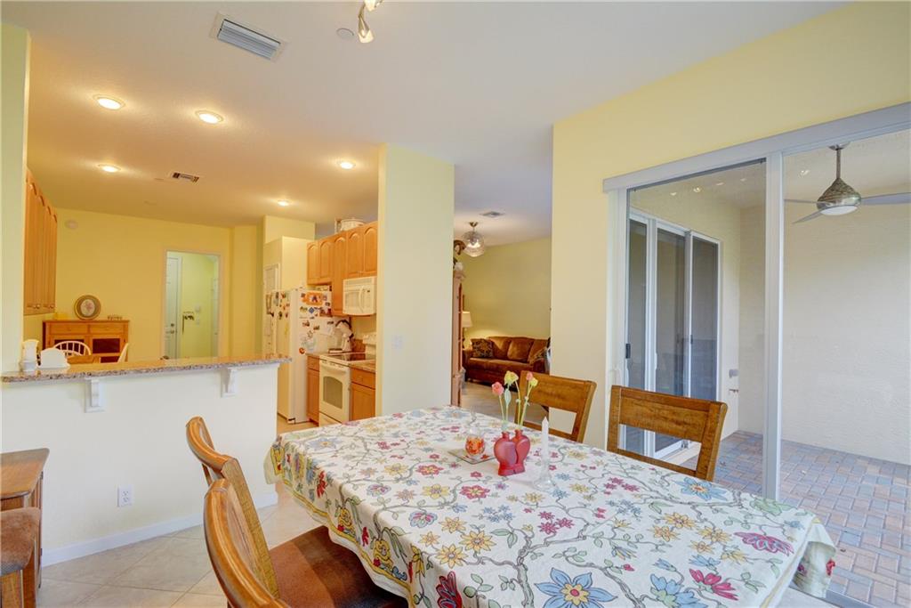138 Southwest Walking Path Stuart, FL 34997 - Photo 13 of 50 a living room with stainless steel appliances furniture a rug kitchen view and a chair