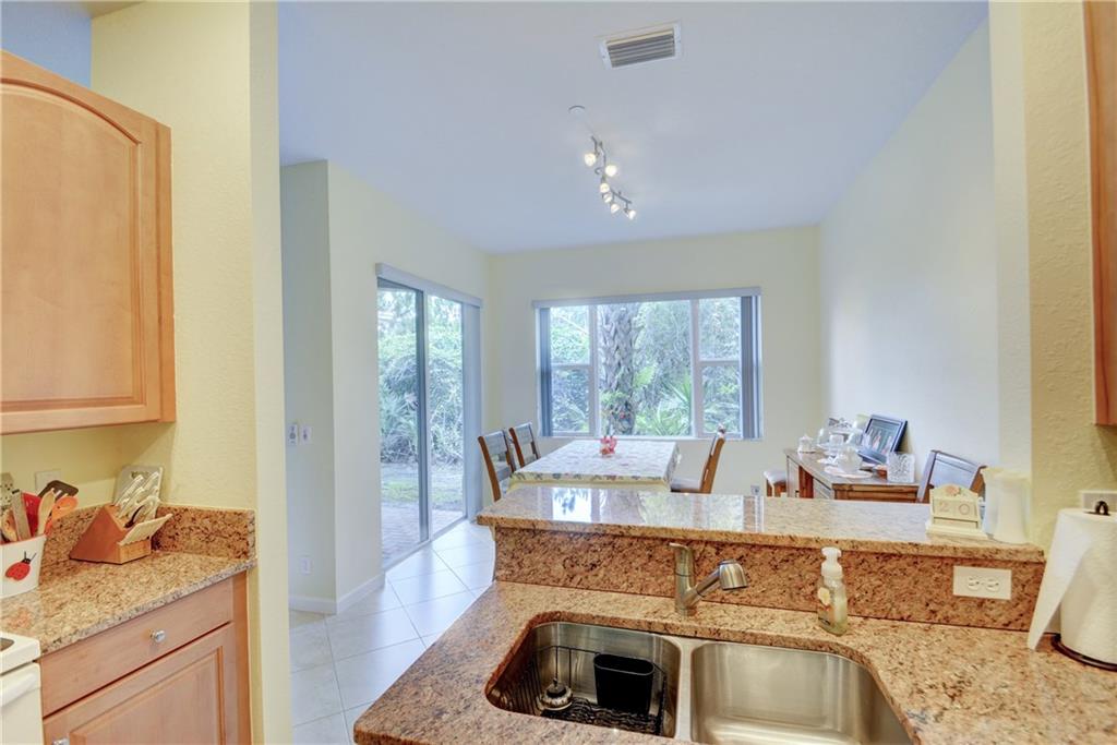 138 Southwest Walking Path Stuart, FL 34997 - Photo 16 of 50 a kitchen with a stove a sink and cabinets