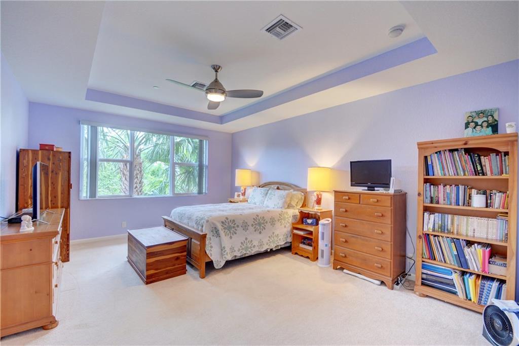 138 Southwest Walking Path Stuart, FL 34997 - Photo 24 of 50 a bedroom with furniture and a book shelf