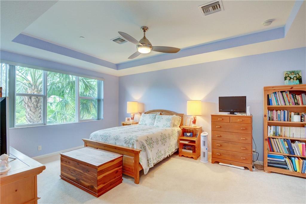 138 Southwest Walking Path Stuart, FL 34997 - Photo 29 of 50 a bedroom with a bed bookshelf and a window