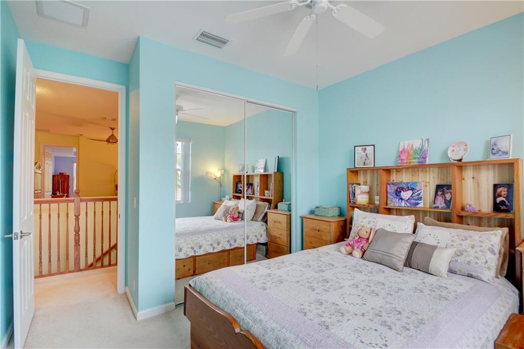 138 Southwest Walking Path Stuart, FL 34997 - Photo 34 of 50 a bedroom with a bed and a large mirror