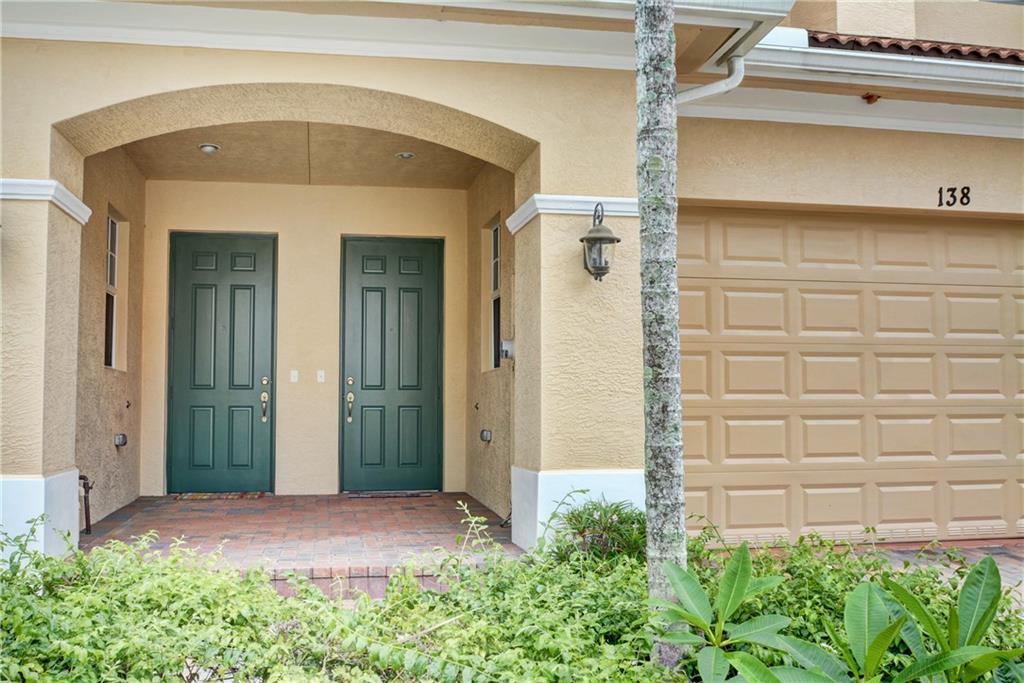 138 Southwest Walking Path Stuart, FL 34997 - Photo 6 of 50 a front view of a house with plants