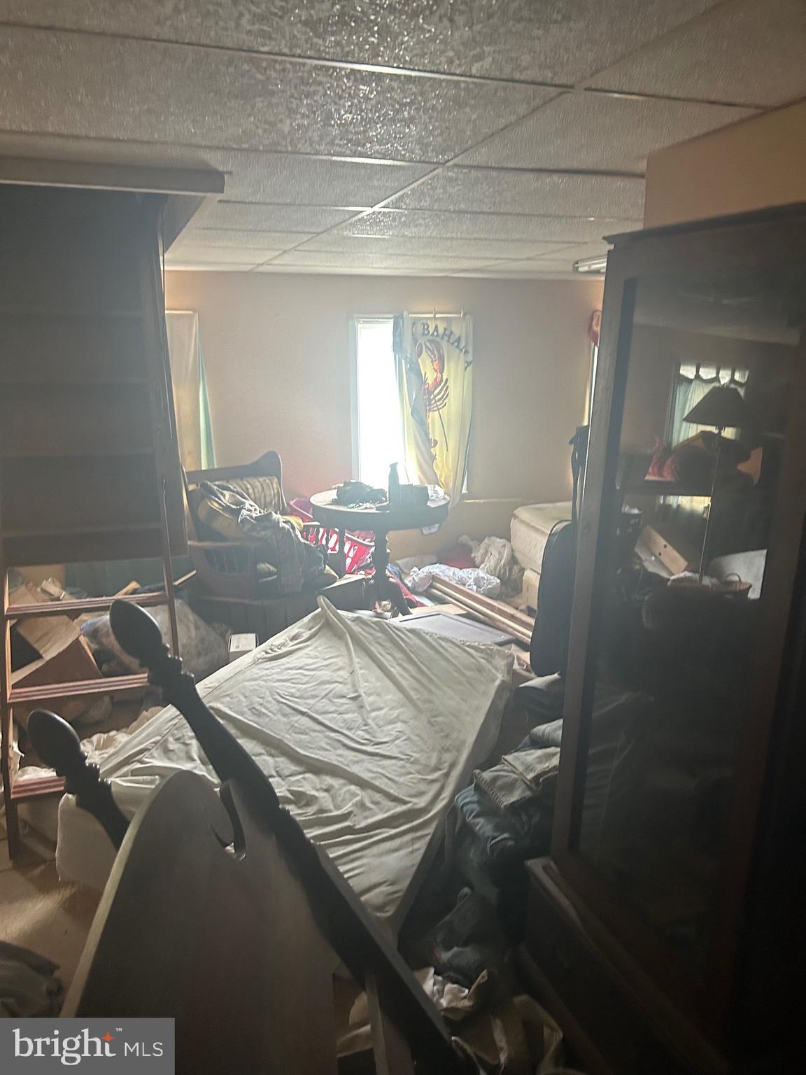 912 Main Street Port Norris, NJ 08349 - Photo 8 of 18 a bed sitting in a bedroom next to a window