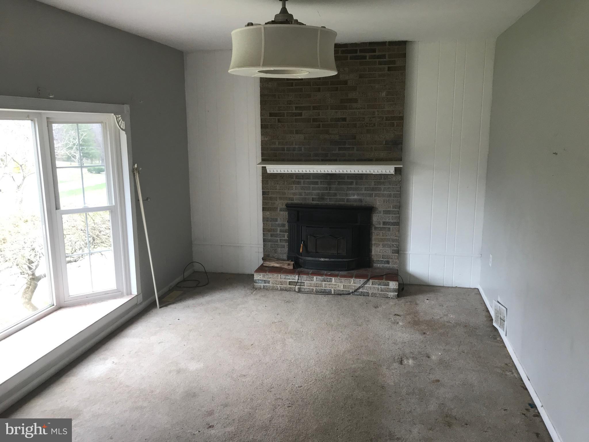 2117 Woodview Road Finksburg, MD 21048 - Photo 3 of 19 an empty room with fireplace and windows