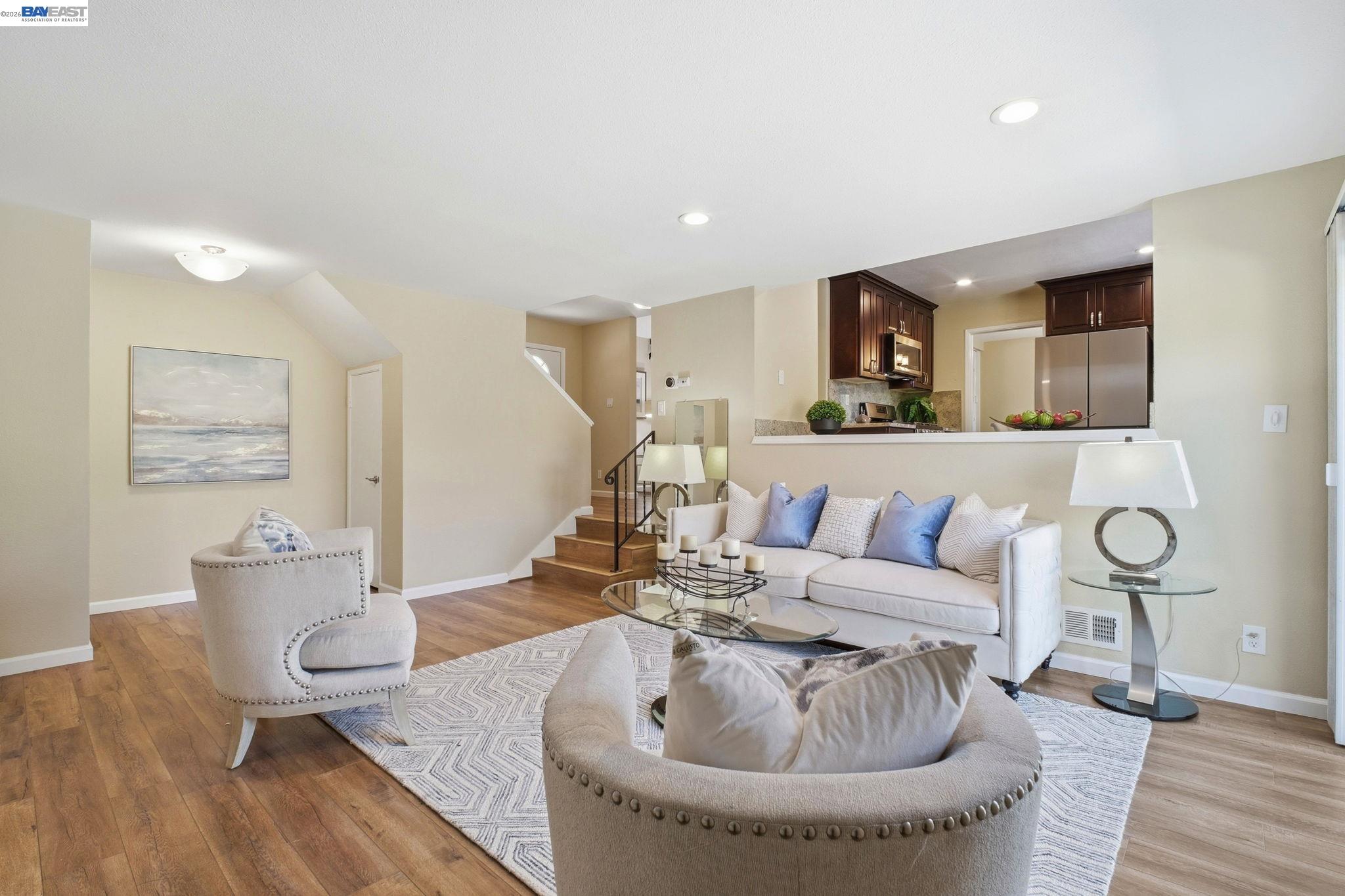 595 Seville Place Fremont, CA 94539 - Photo 13 of 43 a living room with furniture and a wooden floor