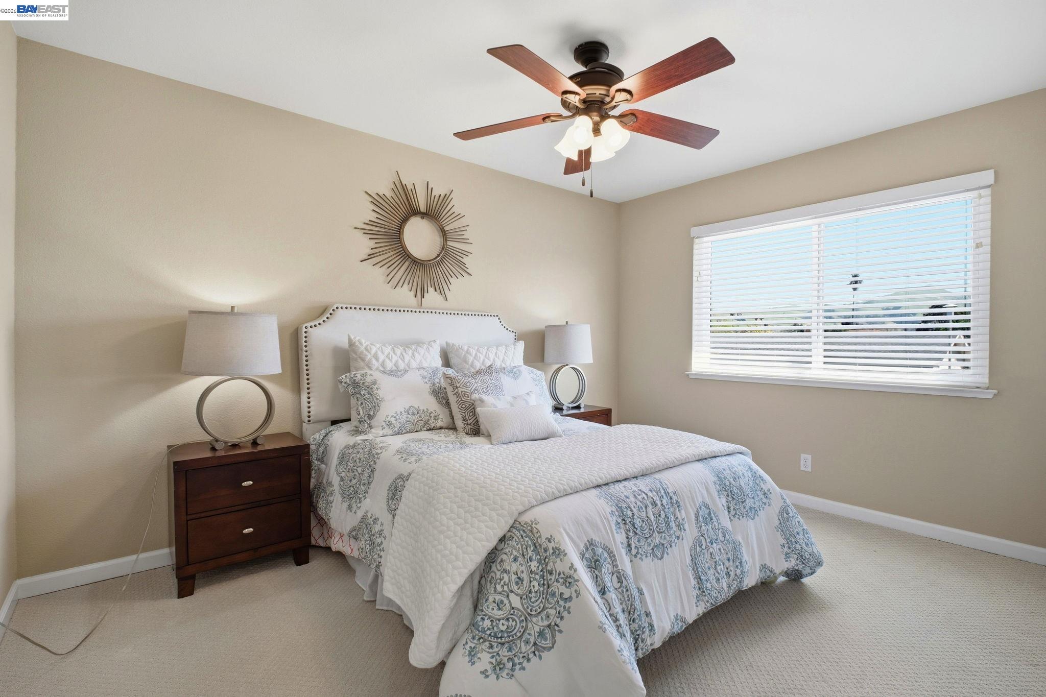 595 Seville Place Fremont, CA 94539 - Photo 19 of 43 a bedroom with a bed and a chandelier