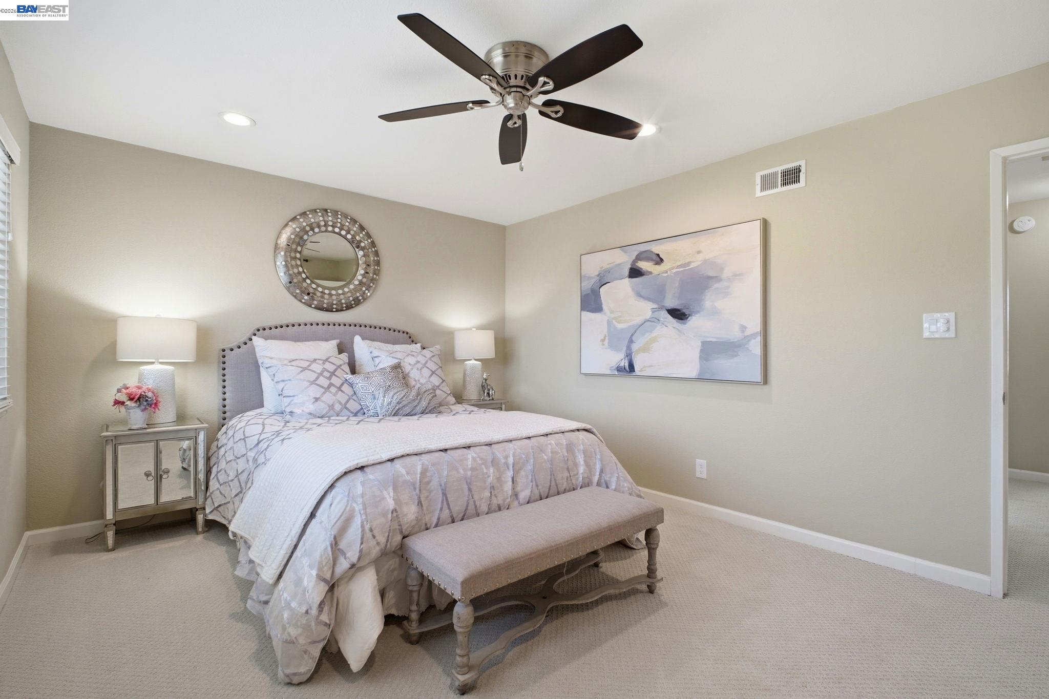 595 Seville Place Fremont, CA 94539 - Photo 21 of 43 a bedroom with a bed and a painting on the wall