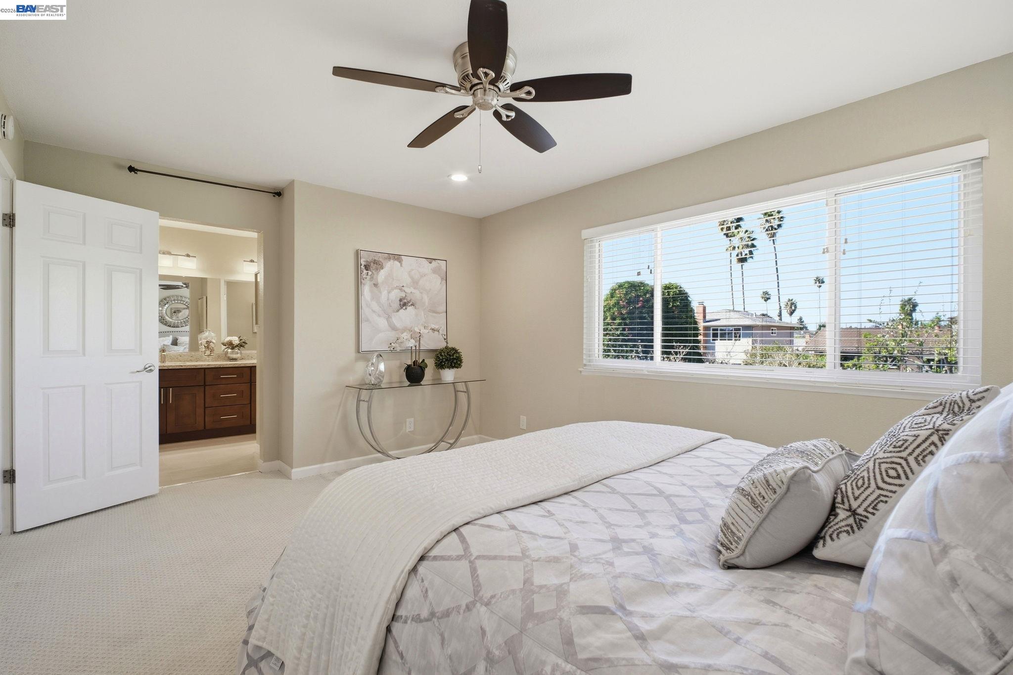 595 Seville Place Fremont, CA 94539 - Photo 22 of 43 a bedroom with a large bed and a chandelier