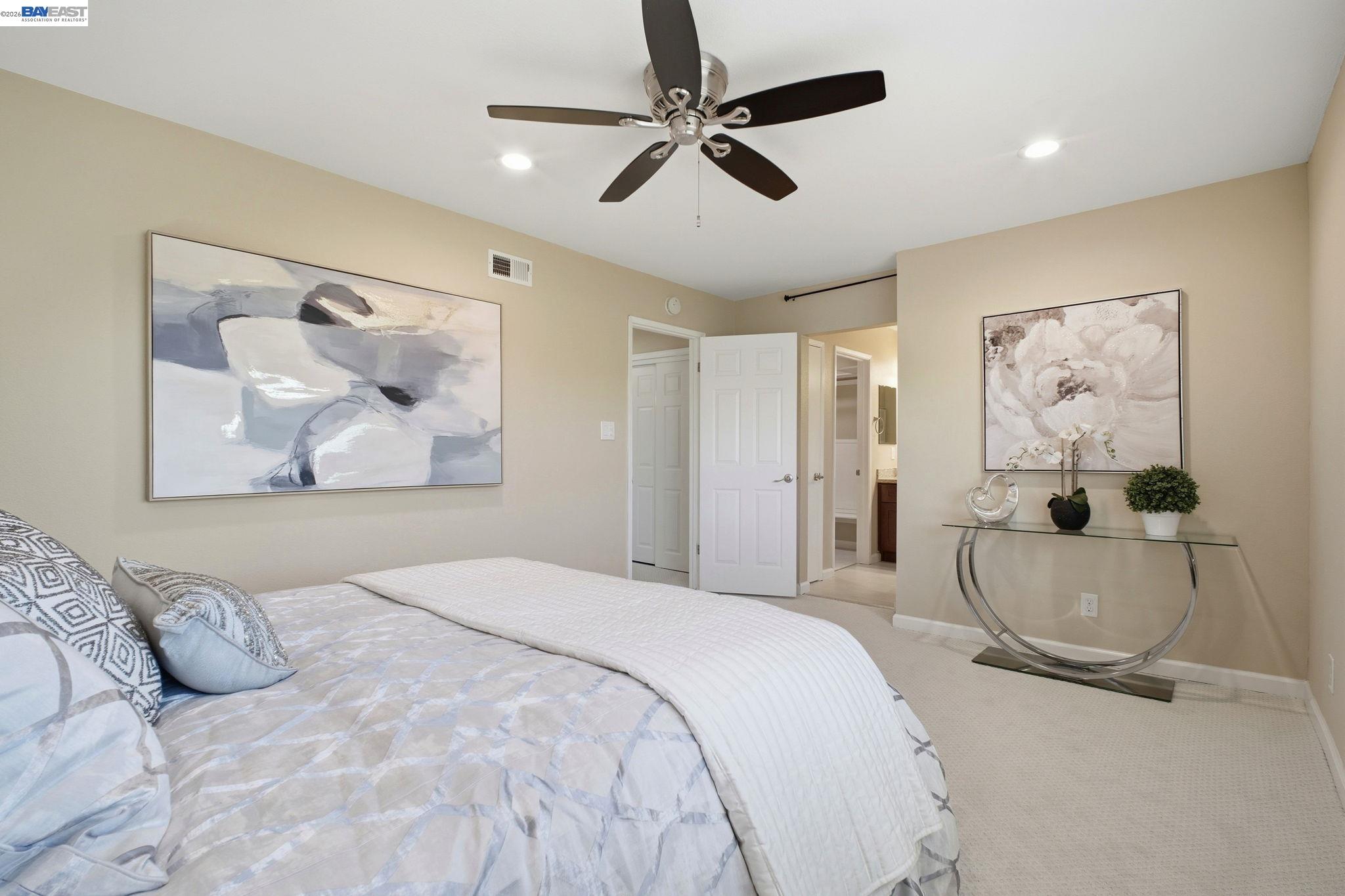 595 Seville Place Fremont, CA 94539 - Photo 23 of 43 a bedroom with a bed and ceiling fan