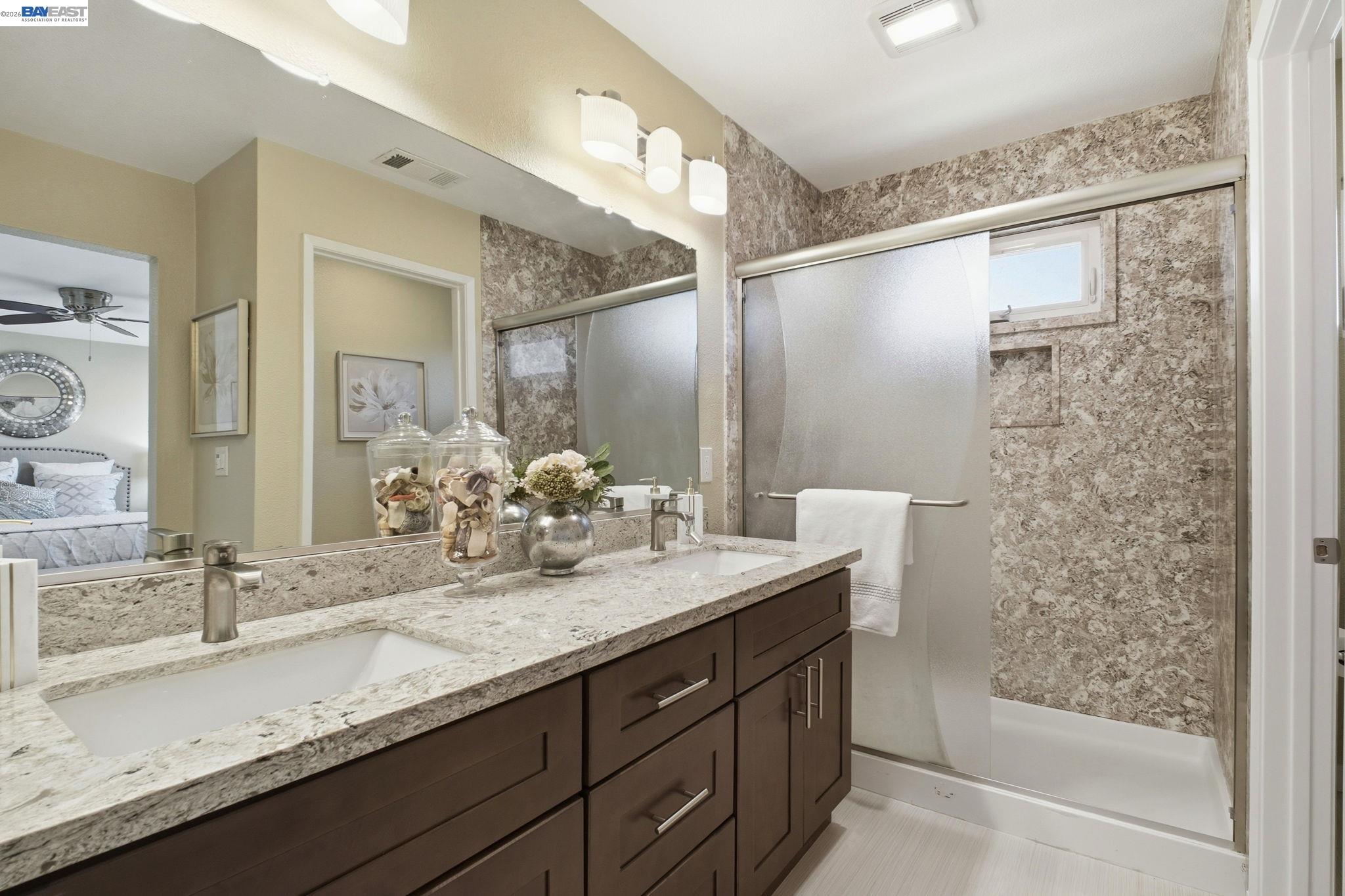 595 Seville Place Fremont, CA 94539 - Photo 25 of 43 a bathroom with a granite countertop sink mirror and double