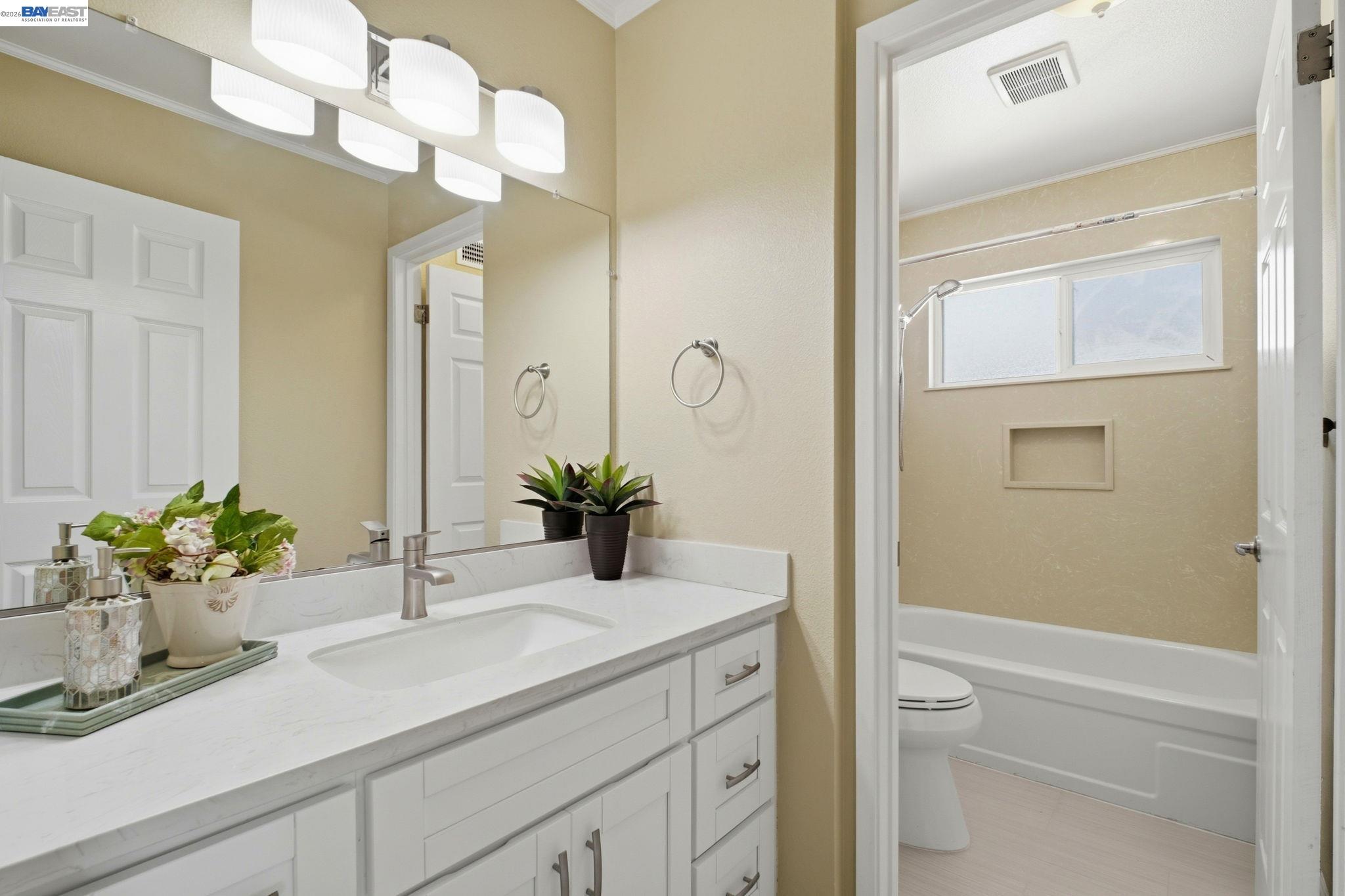 595 Seville Place Fremont, CA 94539 - Photo 27 of 43 a bathroom with a sink a vanity and a mirror