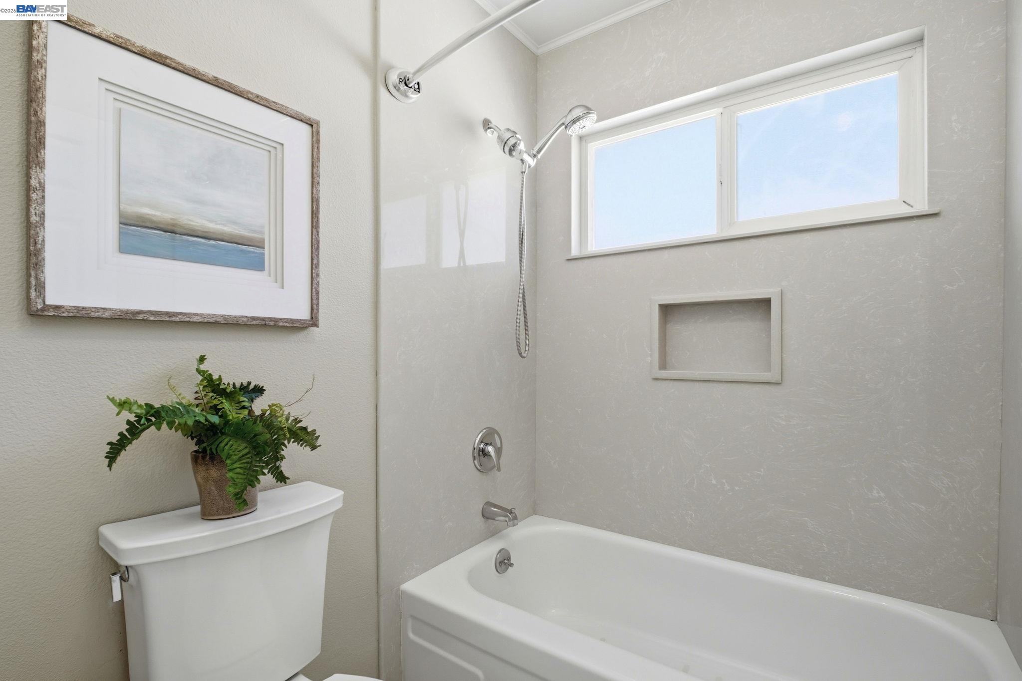 595 Seville Place Fremont, CA 94539 - Photo 28 of 43 a white bath tub sitting next to a white toilet