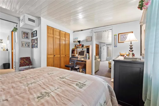 a bed room with a bed and a closet