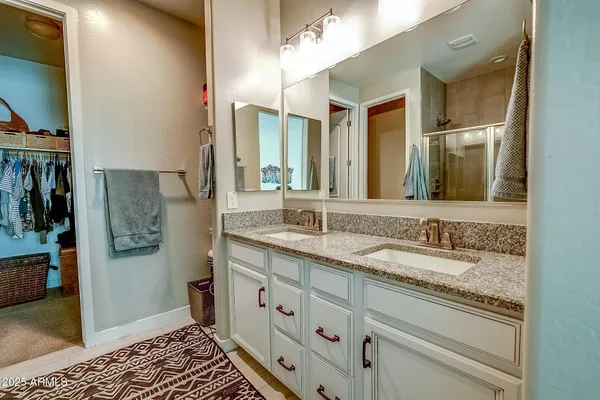 a spacious bathroom with a granite countertop sink and a mirror