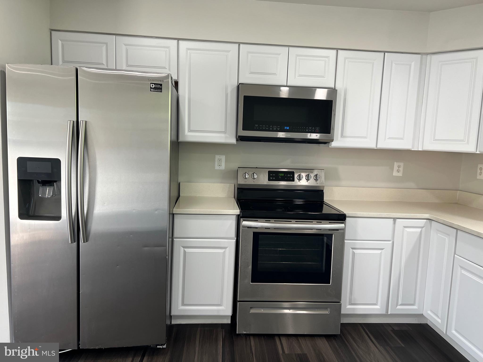 6604 Suitland Road Suitland, MD 20746 - Photo 20 of 27 a kitchen with stainless steel appliances white cabinets and a refrigerator